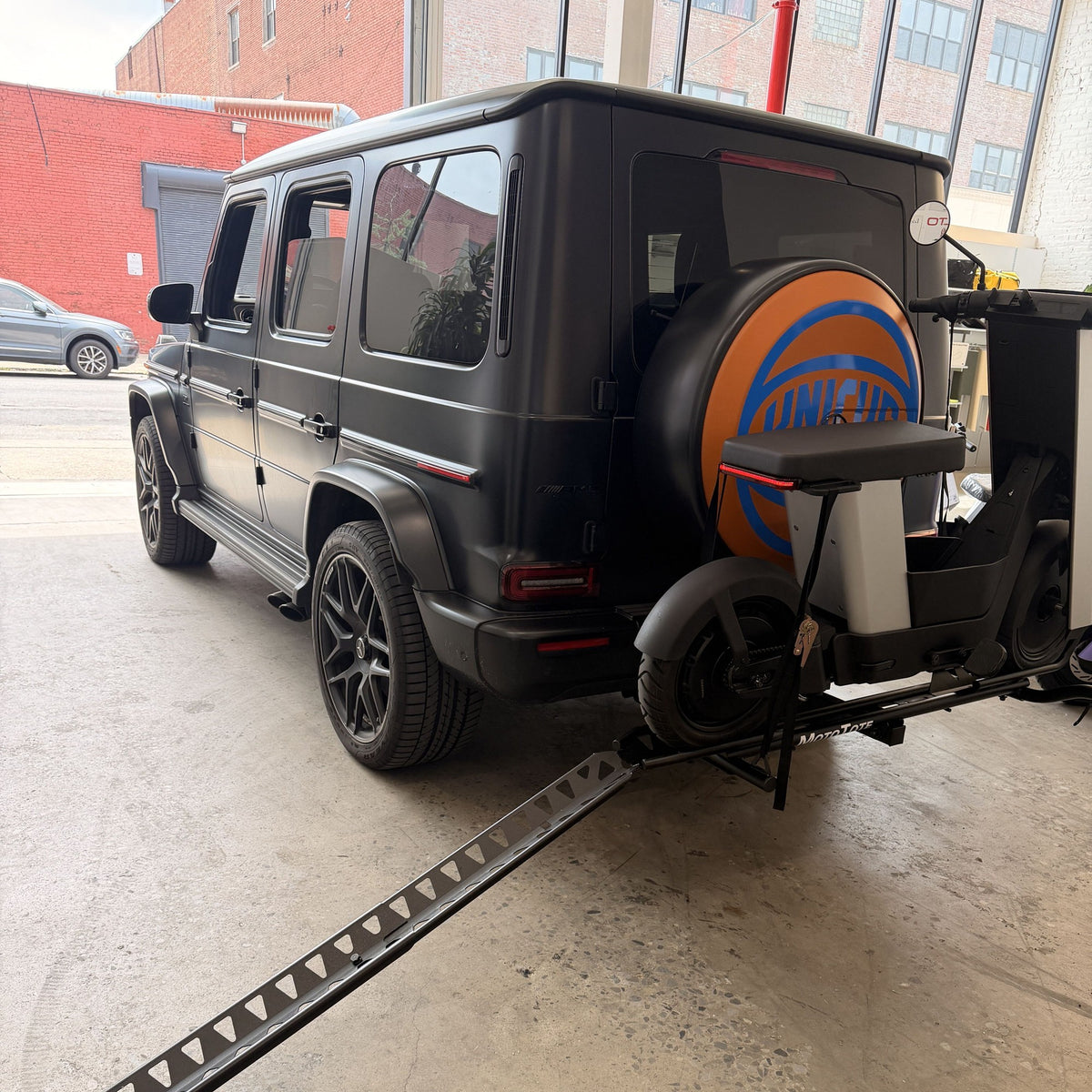 Loading ramp deployed to the ground from the hitch rack, ready to roll an Olto up